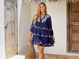 Woman in front of a door wearing a blue and white tie dye spaghetti strap beach dress cover up